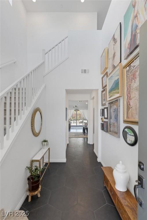 12429 Alpenglow Ct, Las Vegas, NV 89138 - hall featuring a high ceiling, dark tile patterned floors, stairs, and recessed lighting