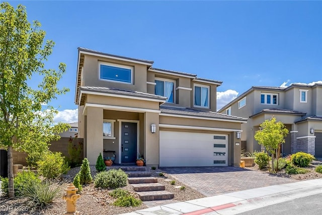 12429 Alpenglow Ct, Las Vegas, NV 89138 - view of front of house with a garage, stucco siding, and decorative driveway