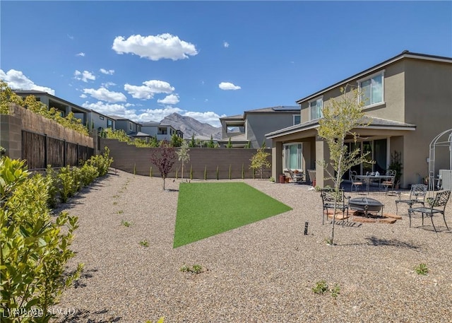 12429 Alpenglow Ct, Las Vegas, NV 89138 - fenced backyard featuring an outdoor fire pit and a patio area