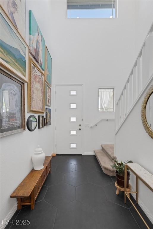 12429 Alpenglow Ct, Las Vegas, NV 89138 - foyer with a towering ceiling, dark tile patterned floors, and stairway