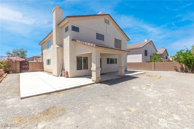 5396 Valley Wells Way, Las Vegas, NV 89113 - rear view of house featuring a patio, a fenced backyard, a chimney, and stucco siding