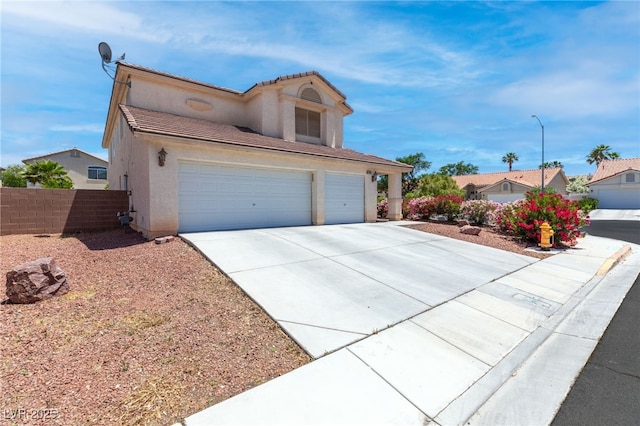 5396 Valley Wells Way, Las Vegas, NV 89113 - view of front facade featuring driveway, an attached garage, stucco siding, fence, and a tiled roof