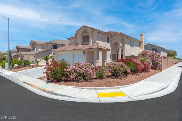 5396 Valley Wells Way, Las Vegas, NV 89113 - view of front of home featuring stucco siding, a tiled roof, driveway, and fence