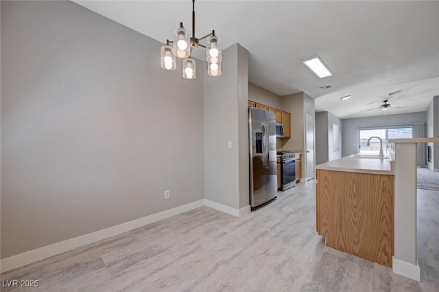 701 Peachy Canyon Cir Unit 201, Las Vegas, NV 89144 - kitchen featuring appliances with stainless steel finishes, a ceiling fan, light wood-type flooring, baseboards, and light countertops