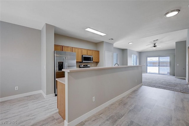 701 Peachy Canyon Cir Unit 201, Las Vegas, NV 89144 - kitchen featuring stainless steel appliances, baseboards, light countertops, a ceiling fan, and open floor plan