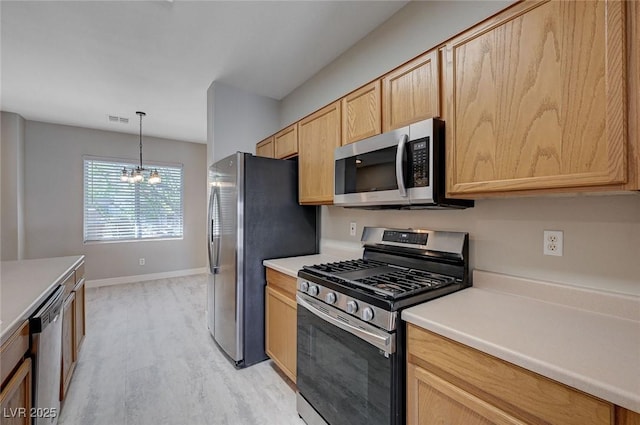 701 Peachy Canyon Cir Unit 201, Las Vegas, NV 89144 - kitchen with appliances with stainless steel finishes, light brown cabinets, light wood-style flooring, a chandelier, and light countertops