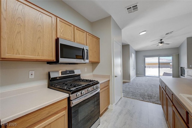701 Peachy Canyon Cir Unit 201, Las Vegas, NV 89144 - kitchen with stainless steel appliances, light brown cabinets, a ceiling fan, and light countertops