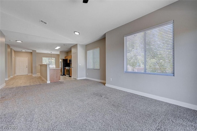 701 Peachy Canyon Cir Unit 201, Las Vegas, NV 89144 - unfurnished living room with baseboards, light colored carpet, and healthy amount of natural light