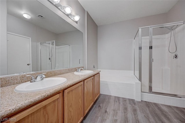 701 Peachy Canyon Cir Unit 201, Las Vegas, NV 89144 - full bathroom featuring a shower stall, double vanity, and wood finished floors