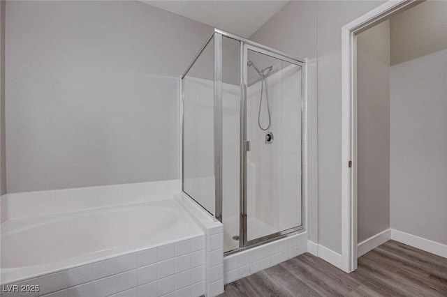 701 Peachy Canyon Cir Unit 201, Las Vegas, NV 89144 - bathroom with a shower stall, a bath, wood finished floors, and baseboards