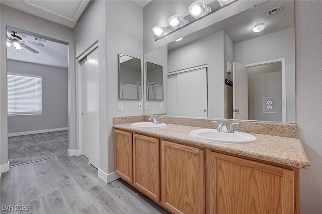 701 Peachy Canyon Cir Unit 201, Las Vegas, NV 89144 - full bathroom with wood finished floors, double vanity, ceiling fan, and baseboards