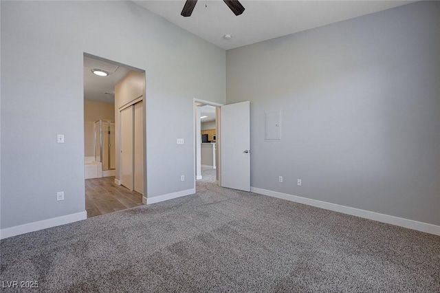 701 Peachy Canyon Cir Unit 201, Las Vegas, NV 89144 - unfurnished bedroom with light carpet, baseboards, and a ceiling fan