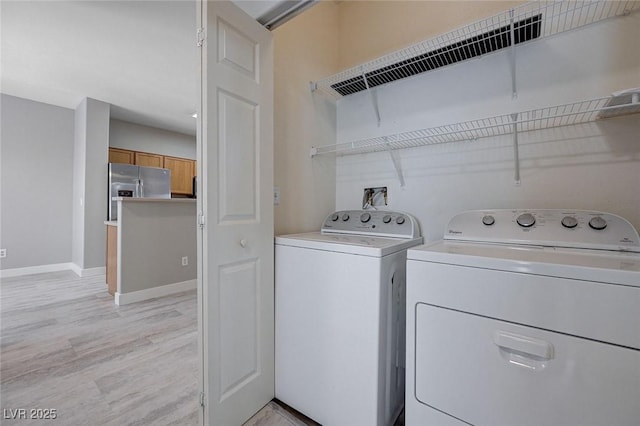 701 Peachy Canyon Cir Unit 201, Las Vegas, NV 89144 - laundry area with separate washer and dryer, light wood-type flooring, and baseboards