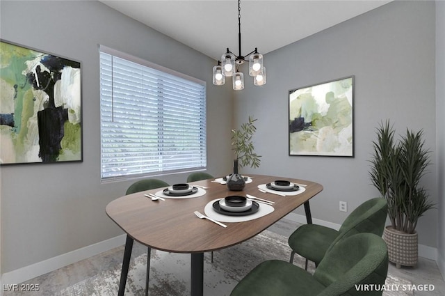 701 Peachy Canyon Cir Unit 201, Las Vegas, NV 89144 - dining room featuring baseboards, a chandelier, and light wood-style flooring