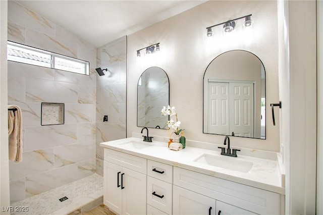 bathroom featuring walk in shower and double vanity
