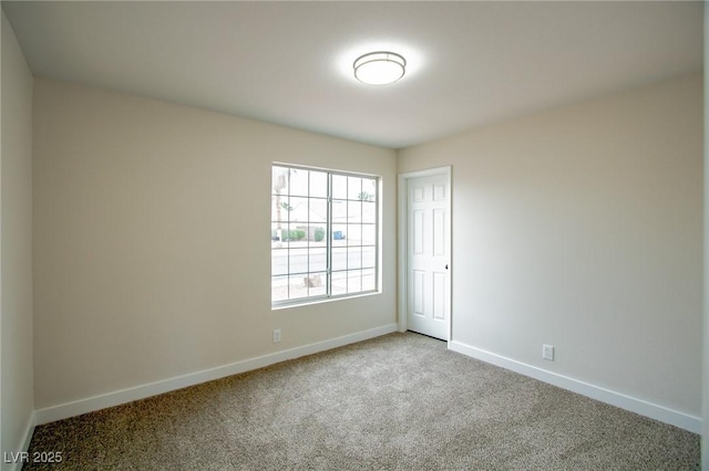 unfurnished room featuring baseboards and carpet flooring