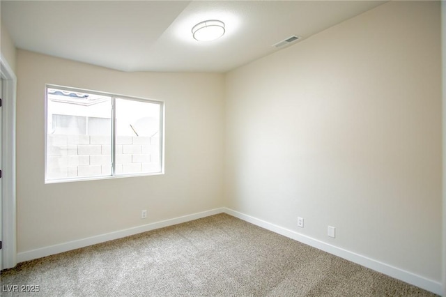 carpeted spare room featuring baseboards