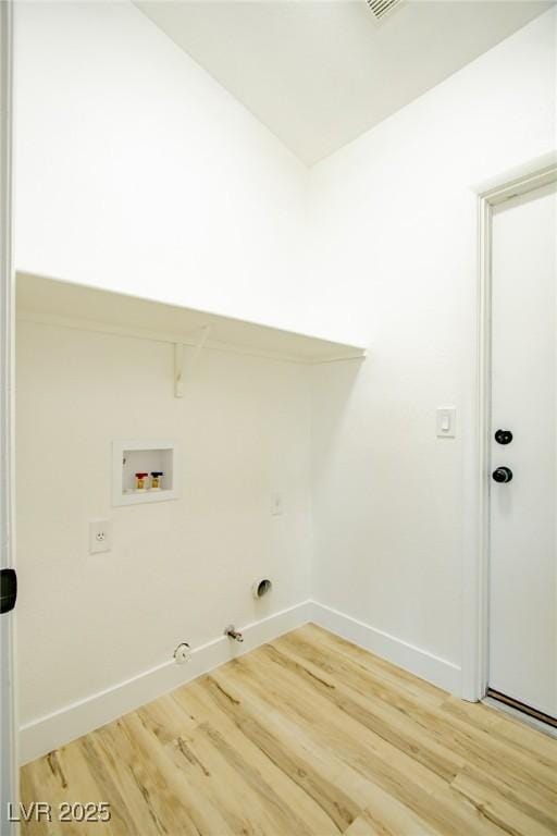 clothes washing area with hookup for a washing machine, hookup for a gas dryer, light wood finished floors, and baseboards