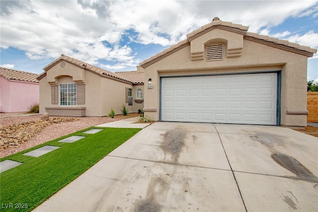 mediterranean / spanish-style home featuring a tile roof, concrete driveway, stucco siding, and a garage