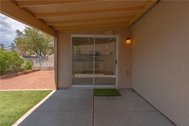 doorway to property with a patio and stucco siding