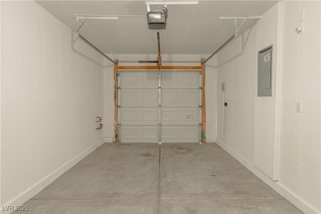garage with a garage door opener, electric panel, and baseboards