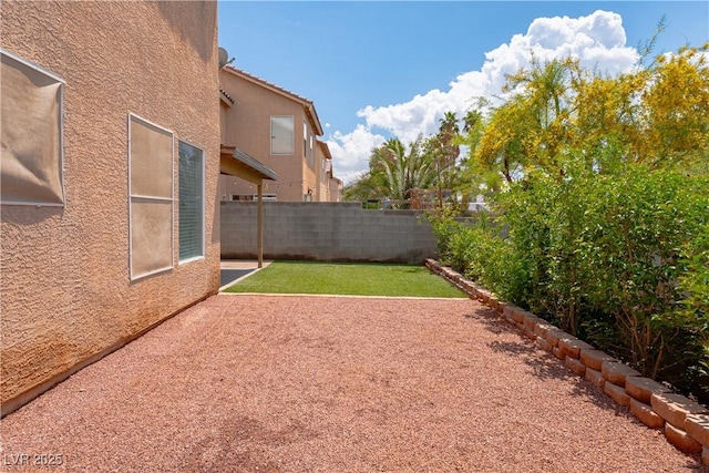 fenced backyard with a patio area