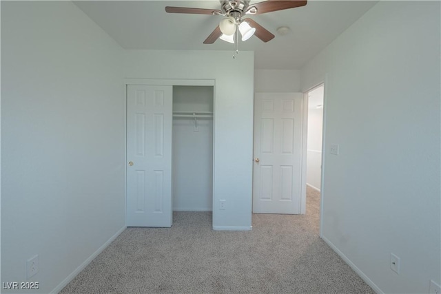 unfurnished bedroom featuring carpet floors, baseboards, a closet, and ceiling fan