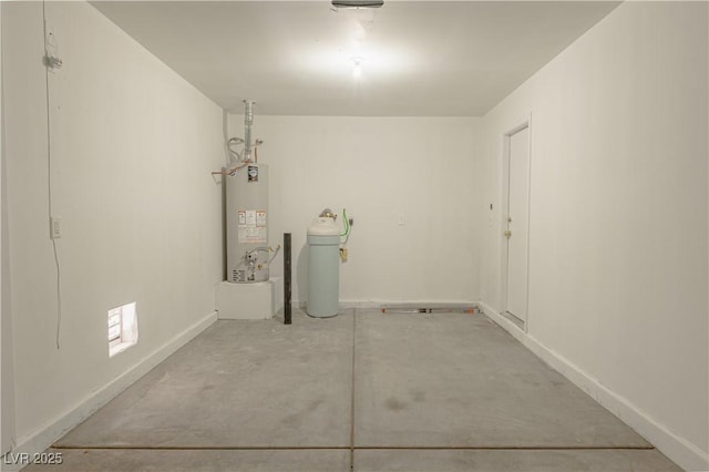 clothes washing area featuring water heater and baseboards