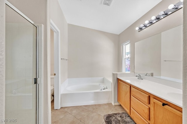 full bath featuring tile patterned floors, a garden tub, a shower stall, and toilet