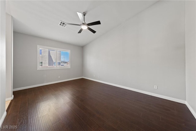 unfurnished room with vaulted ceiling, a ceiling fan, dark wood-style floors, and baseboards