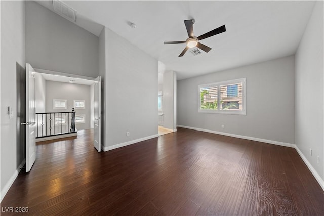 spare room featuring wood finished floors, a ceiling fan, and baseboards