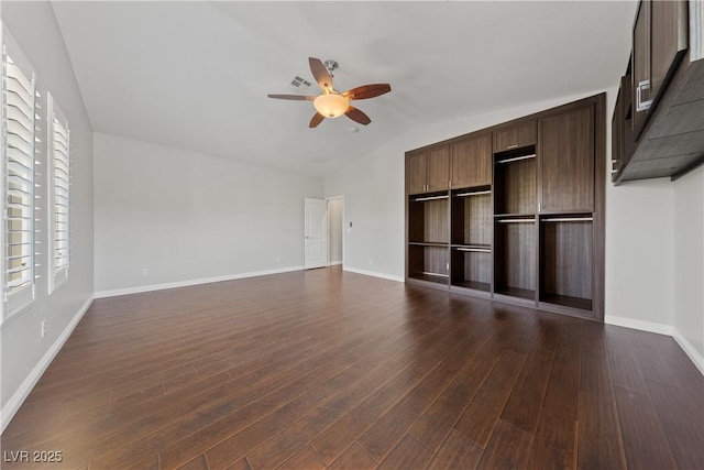 unfurnished living room with a ceiling fan, dark wood-style flooring, baseboards, and lofted ceiling