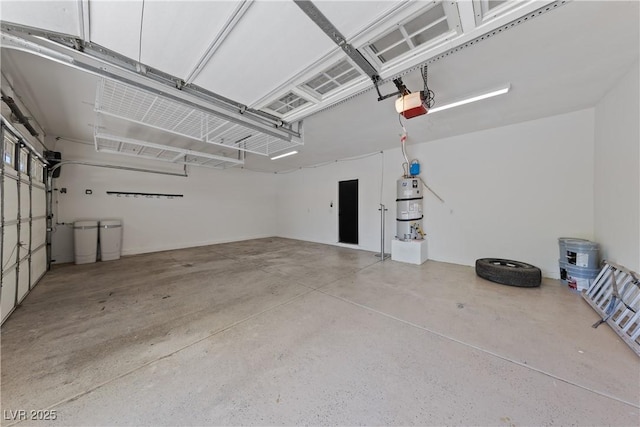 garage featuring a garage door opener and strapped water heater