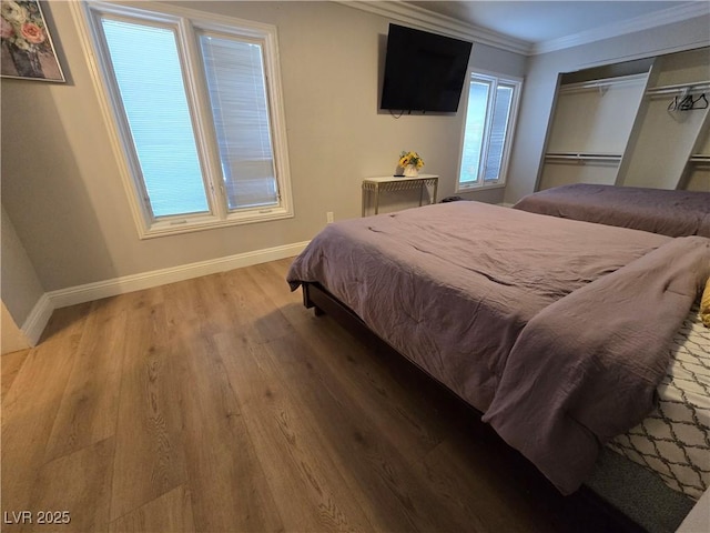 5515 Coley Ave, Las Vegas, NV 89146 - bedroom with wood finished floors, baseboards, ornamental molding, and a closet
