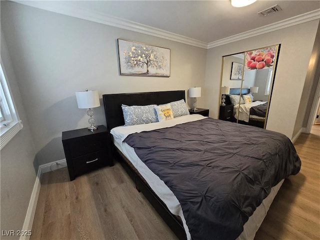 5515 Coley Ave, Las Vegas, NV 89146 - bedroom with wood finished floors, ornamental molding, baseboards, and a closet