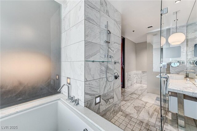 4381 W Flamingo Rd Unit 3206, Las Vegas, NV 89103 - bathroom with a stall shower, marble finish floors, vanity, tile walls, and a bath