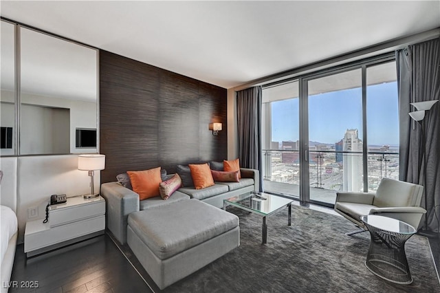 4381 W Flamingo Rd Unit 3206, Las Vegas, NV 89103 - living room featuring a wall of windows, dark wood finished floors, and a view of city