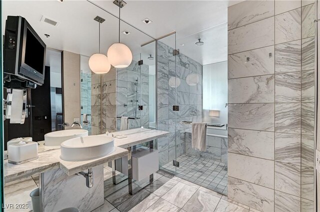 4381 W Flamingo Rd Unit 3206, Las Vegas, NV 89103 - bathroom featuring a stall shower, a sink, and marble finish floors