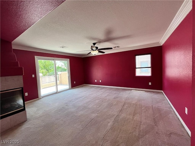 2112 Merganser Ct, North Las Vegas, NV 89084 - unfurnished living room with crown molding, a textured ceiling, carpet flooring, a ceiling fan, and a tiled fireplace