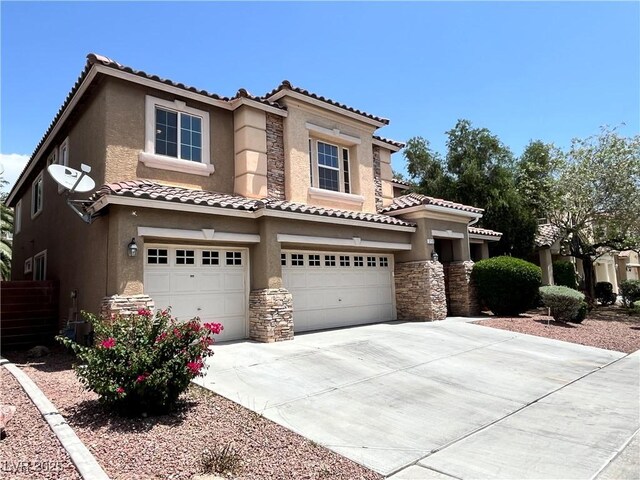 2112 Merganser Ct, North Las Vegas, NV 89084 - view of front of home featuring an attached garage, stone siding, stucco siding, and a tile roof