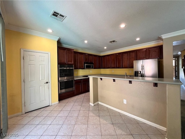 2112 Merganser Ct, North Las Vegas, NV 89084 - kitchen with appliances with stainless steel finishes, a kitchen breakfast bar, ornamental molding, light countertops, and recessed lighting