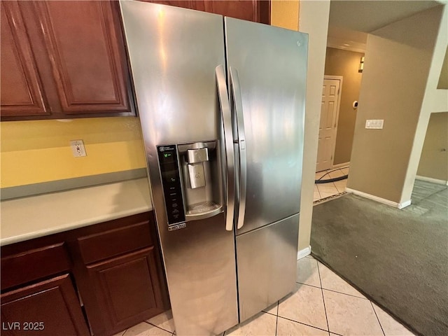 2112 Merganser Ct, North Las Vegas, NV 89084 - kitchen with stainless steel fridge, light carpet, light tile patterned floors, and light countertops
