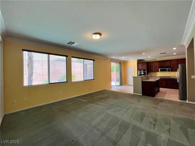 2112 Merganser Ct, North Las Vegas, NV 89084 - unfurnished living room with ornamental molding, light carpet, baseboards, recessed lighting, and a sink