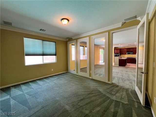 2112 Merganser Ct, North Las Vegas, NV 89084 - carpeted empty room with crown molding, french doors, and baseboards