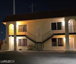 back of house at night featuring stairs