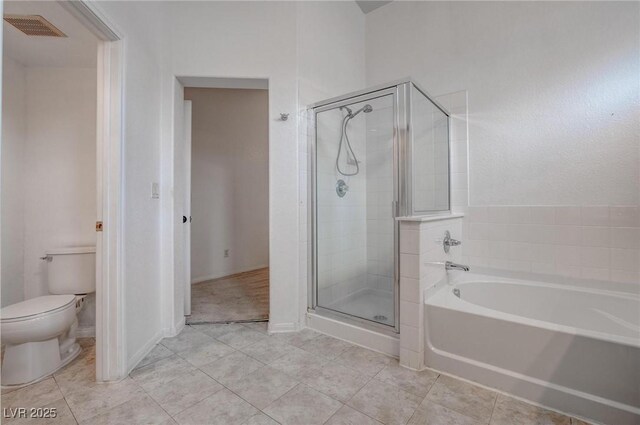 bathroom with toilet, a stall shower, a garden tub, and tile patterned floors