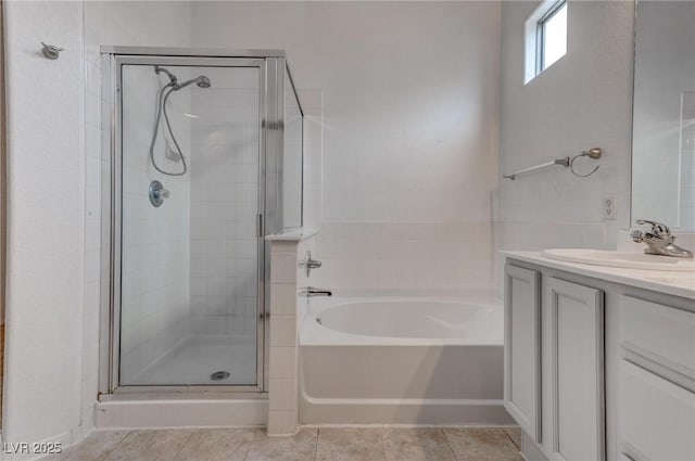 full bathroom with a shower stall, tile patterned flooring, a bath, and vanity
