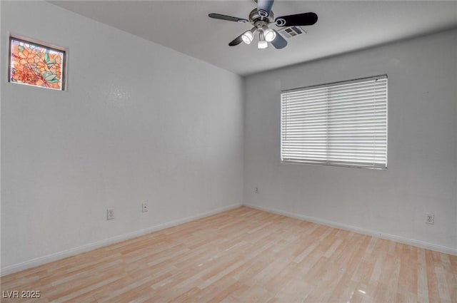 empty room featuring wood finished floors, a ceiling fan, and baseboards