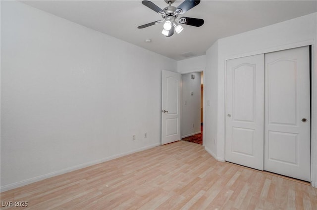 unfurnished bedroom with light wood finished floors, baseboards, a closet, and ceiling fan