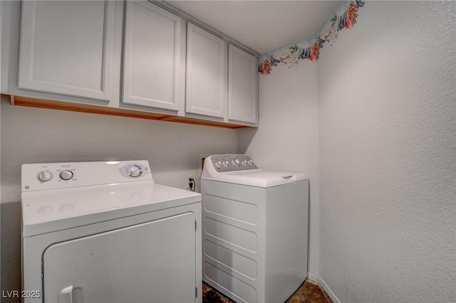 laundry room featuring cabinet space, washer and dryer, and baseboards